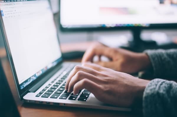 Person browsing listings on a laptop